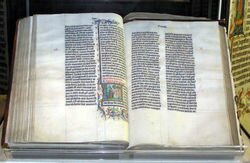 A Bible handwritten in Latin, on display in Malmesbury Abbey, Wiltshire, England. This Bible was transcribed in Belgium in 1407 for reading aloud in a monastery.