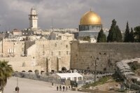 The Western Wall of Jerusalem with the dome of the rock in the background.